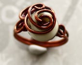 Ivory lampwork glass wrapped with solid copper wire ring. Size 7.5