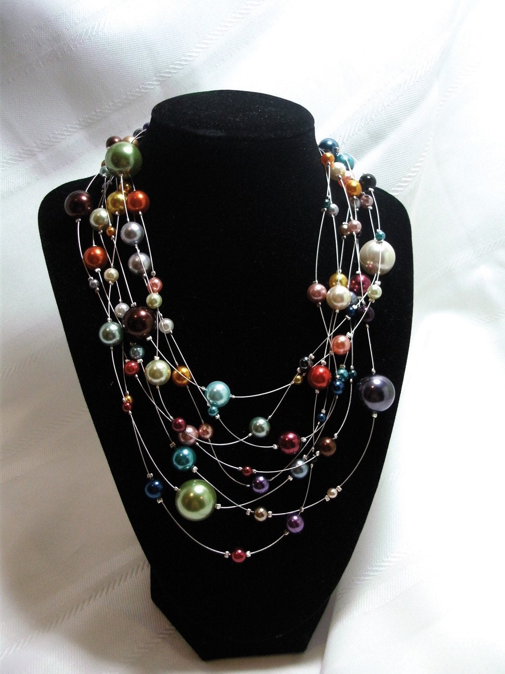 Multiple colors and sizes of pearls on a 4 silver wire strands