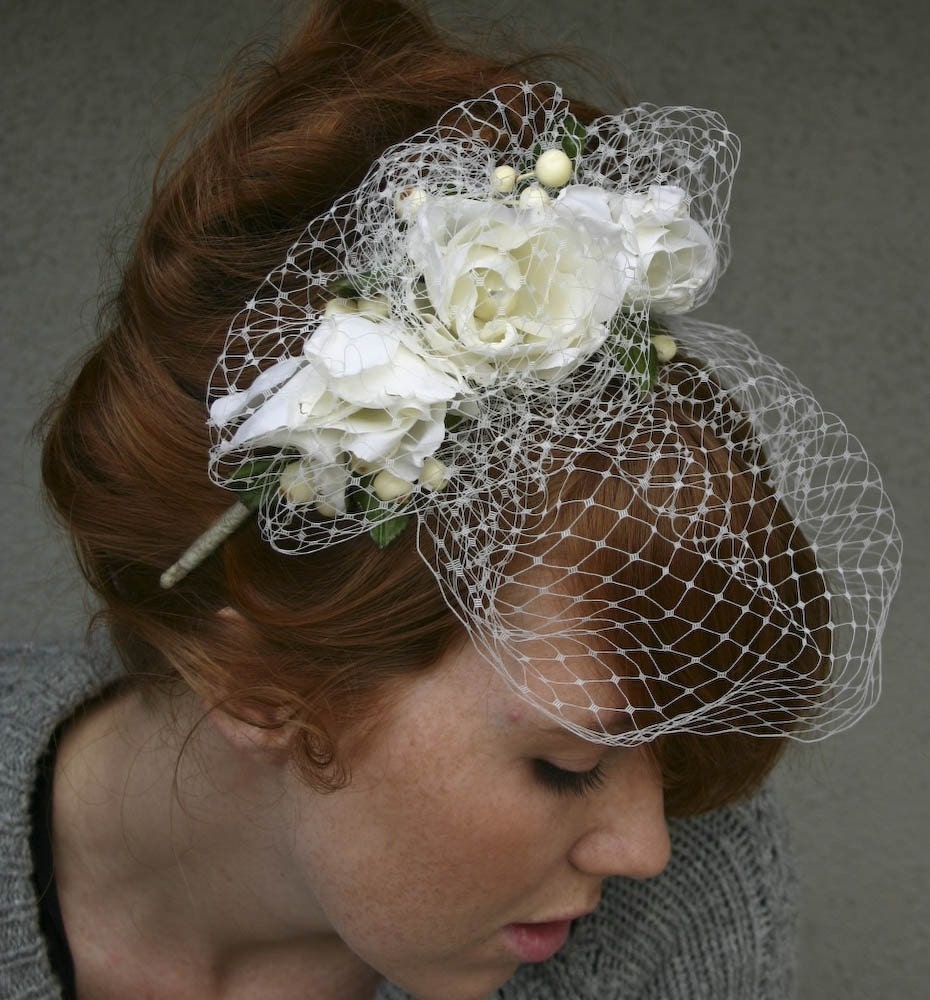 Flower bridal hair accessories and bird cage veils are making a huge 