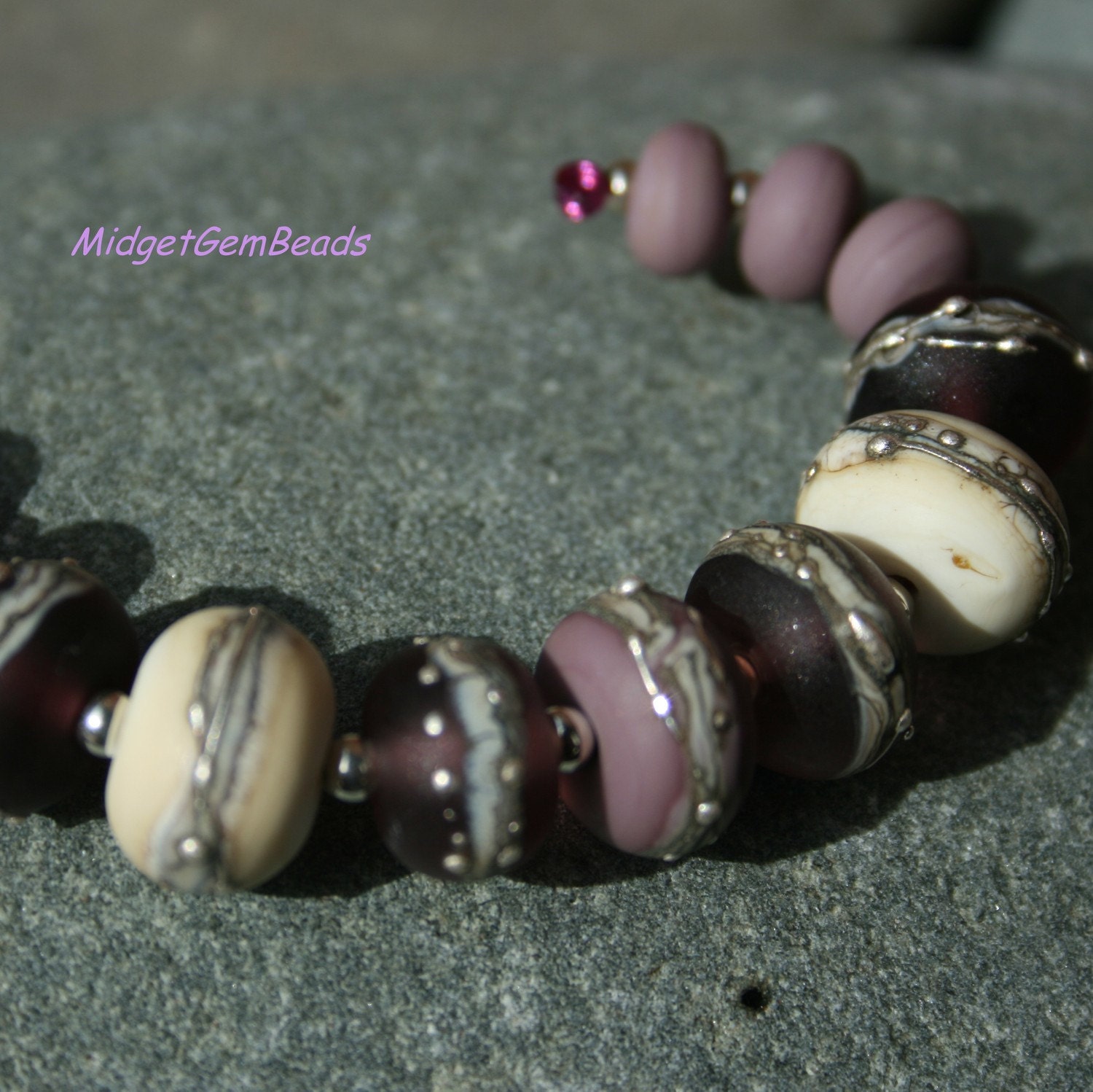 Rich purples combine with stone like ivory in this set of beads.
