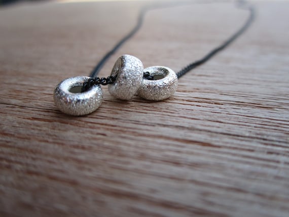 necklace- sterling stardust discs on black chain