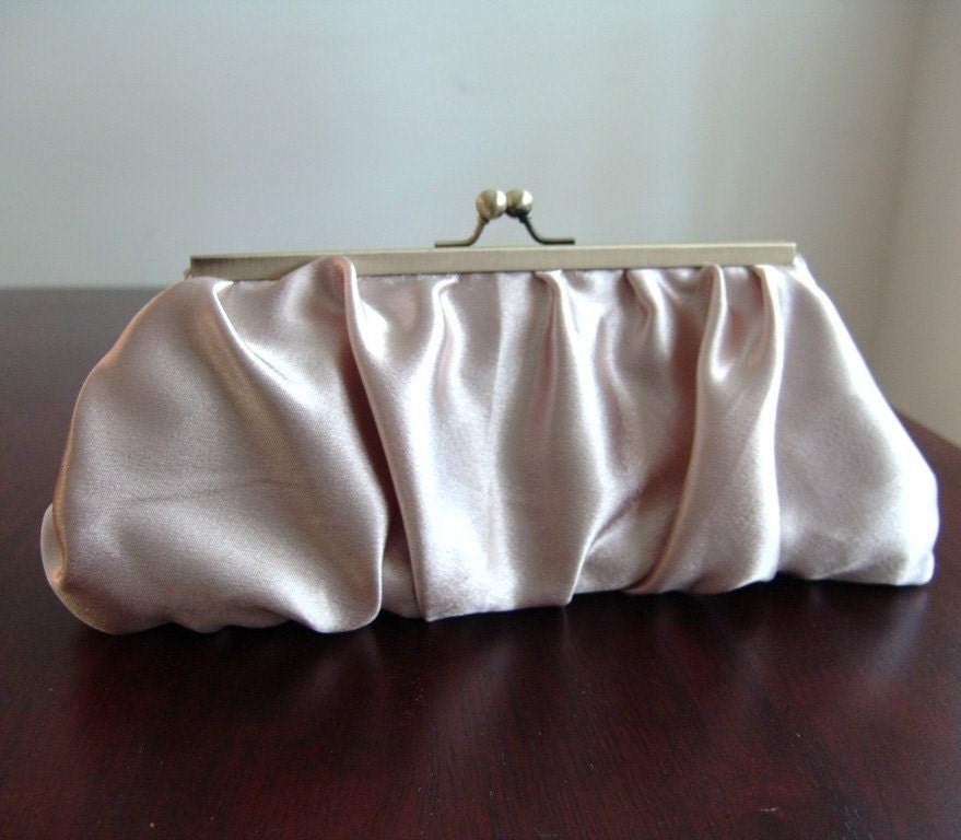 Satin clutch in purse frame. Gathered champagne