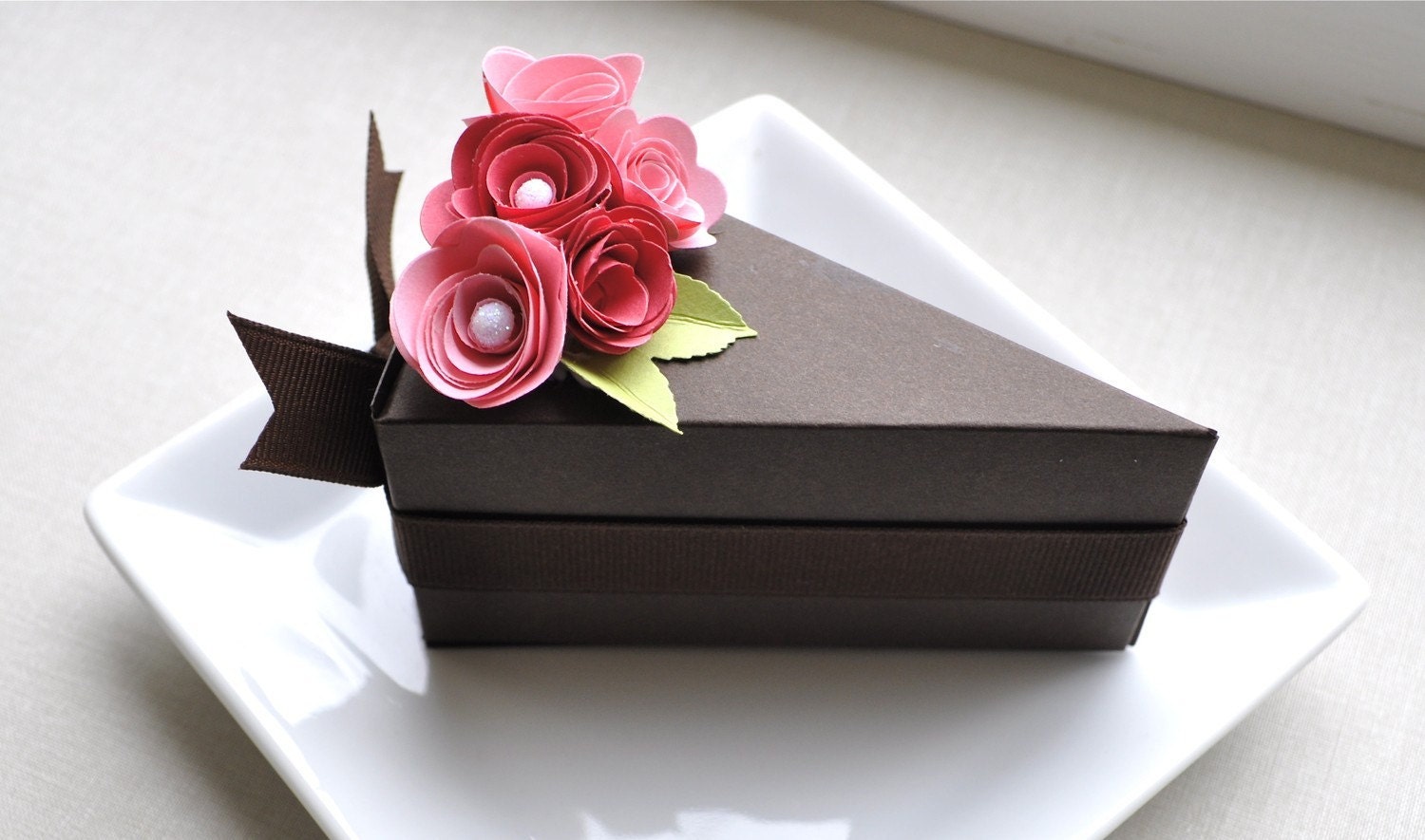Chocolate paper cake slice with two toned pink flowers