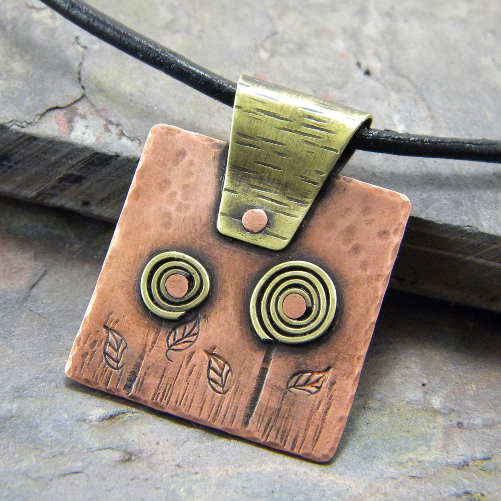 necklace. whimsical brass flowers, copper square pendant, black leather cord