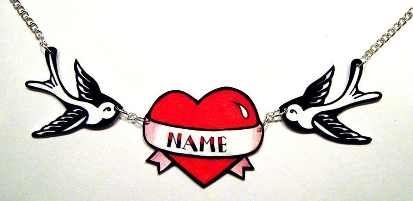 Swallow with personalised heart Tattoo inspired necklace! Two matching black & white swallows hold a tattoo style heart in the centre, with a banner that 