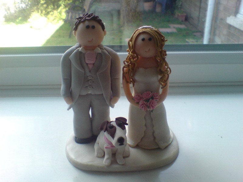 Cake toppers designed to look like the happy couple Hunters Designs
