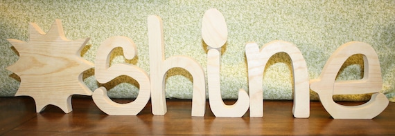 UNFINISHED SUNSHINE wood letters with a sun for the "SUN".