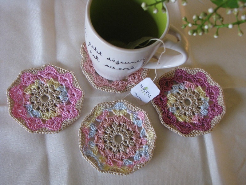 Set of four coasters in a combination of soft spring colors, beige, pink, wine red...