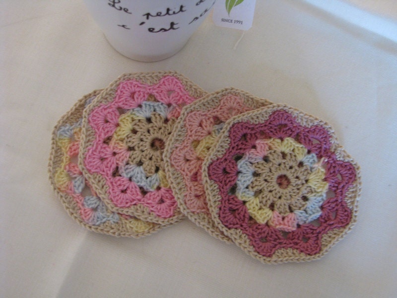 Set of four coasters in a combination of soft spring colors, beige, pink, wine red...