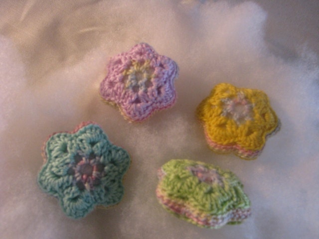 crocheted flowers in four joyful pastel colors - lilac, blue, green and yellow
