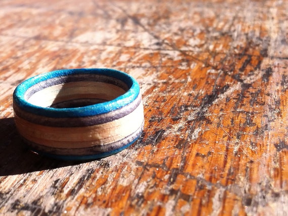 Rings with a light blue stripe hand cut from skateboard decks