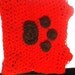 Super Cute Doggie Sweater with a paw crocheted on it.