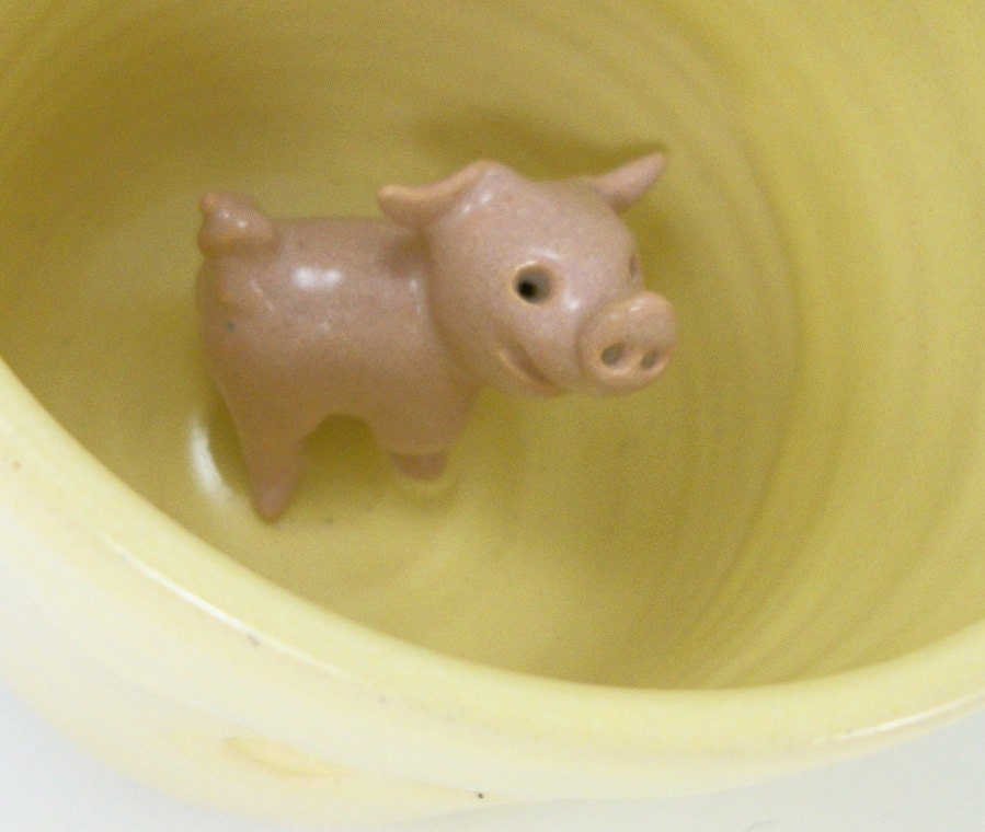 yellow mug with a piggy inside